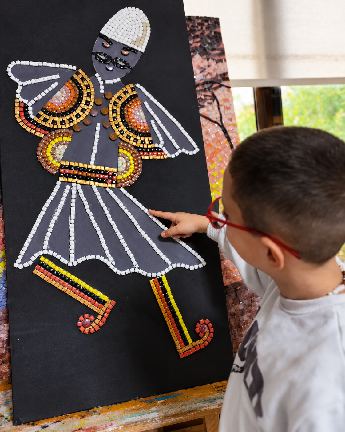 Child exploring traditional Albanian mosaic art at a workshop in Tirana