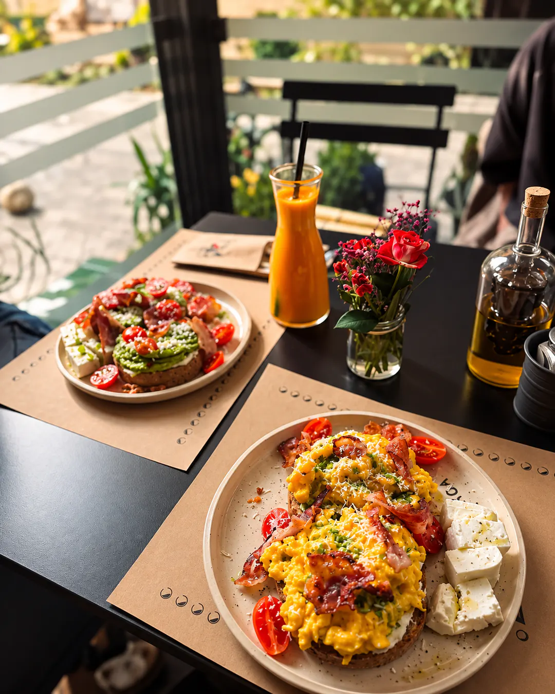 Brunch spread with scrambled eggs, avocado toast and fresh juice at KOA Brunch & Vino in Tirana