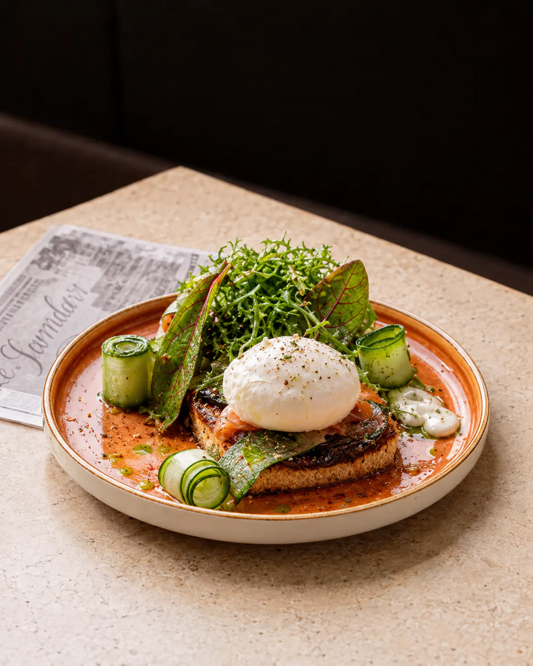 Poached egg toast and fresh greens for brunch at Oborri in Tirana
