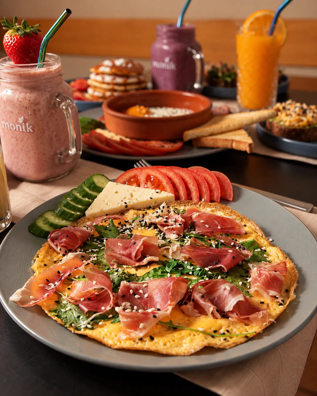 Savory breakfast plate with prosciutto, greens and fresh vegetables at Savory in Tirana