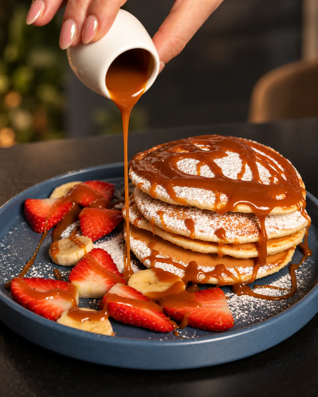 Pancakes with strawberries, banana and caramel sauce at Savory in Tirana