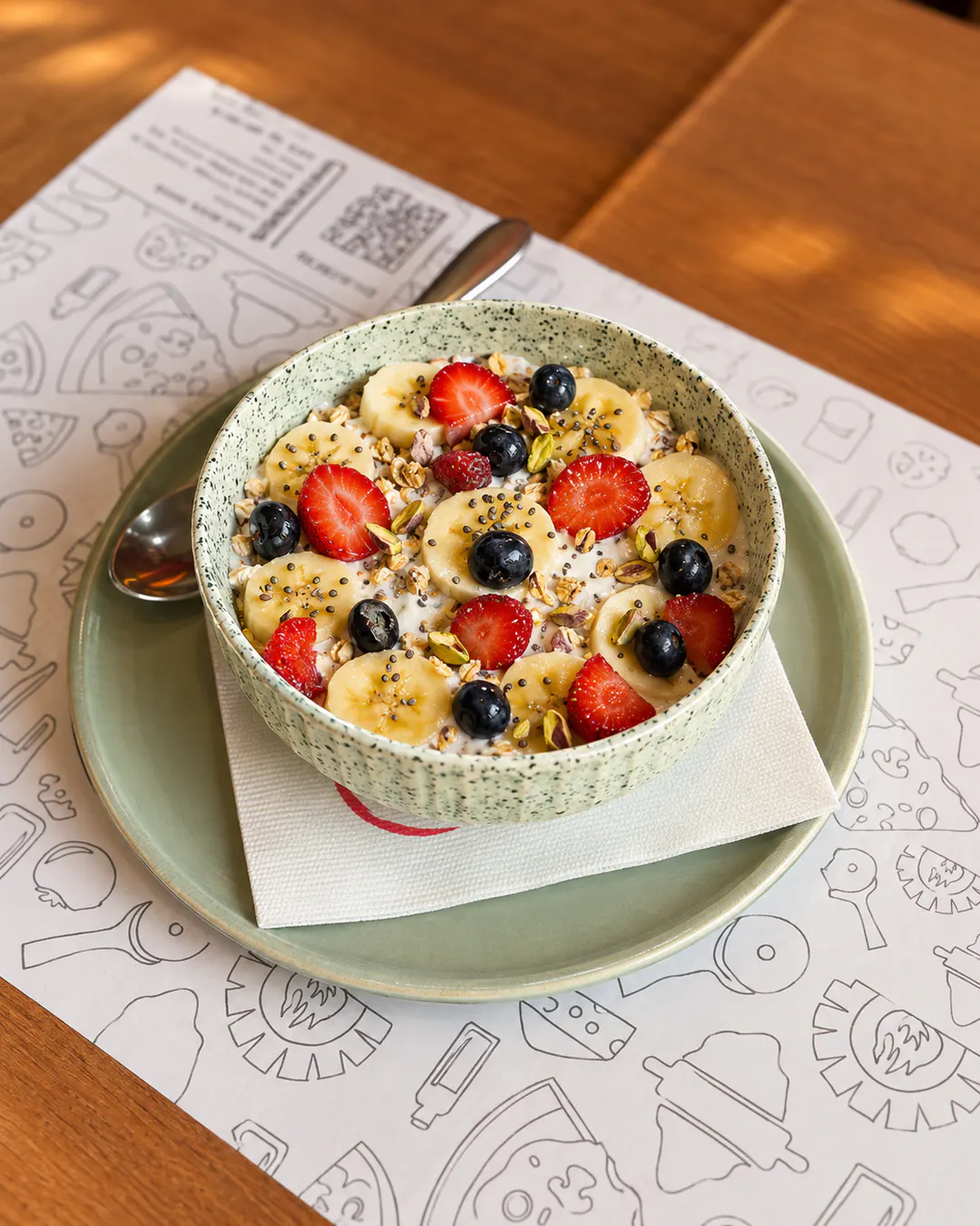 Breakfast bowl with banana, strawberries and blueberries at Tony's in Tirana