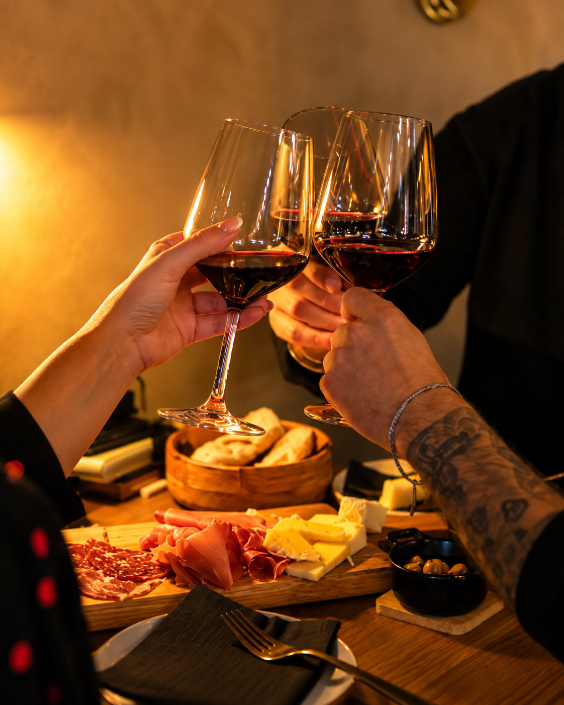 Guests enjoying red wine with charcuterie and cheese at SÒRSO Wine Bar & Kitchen in Tirana