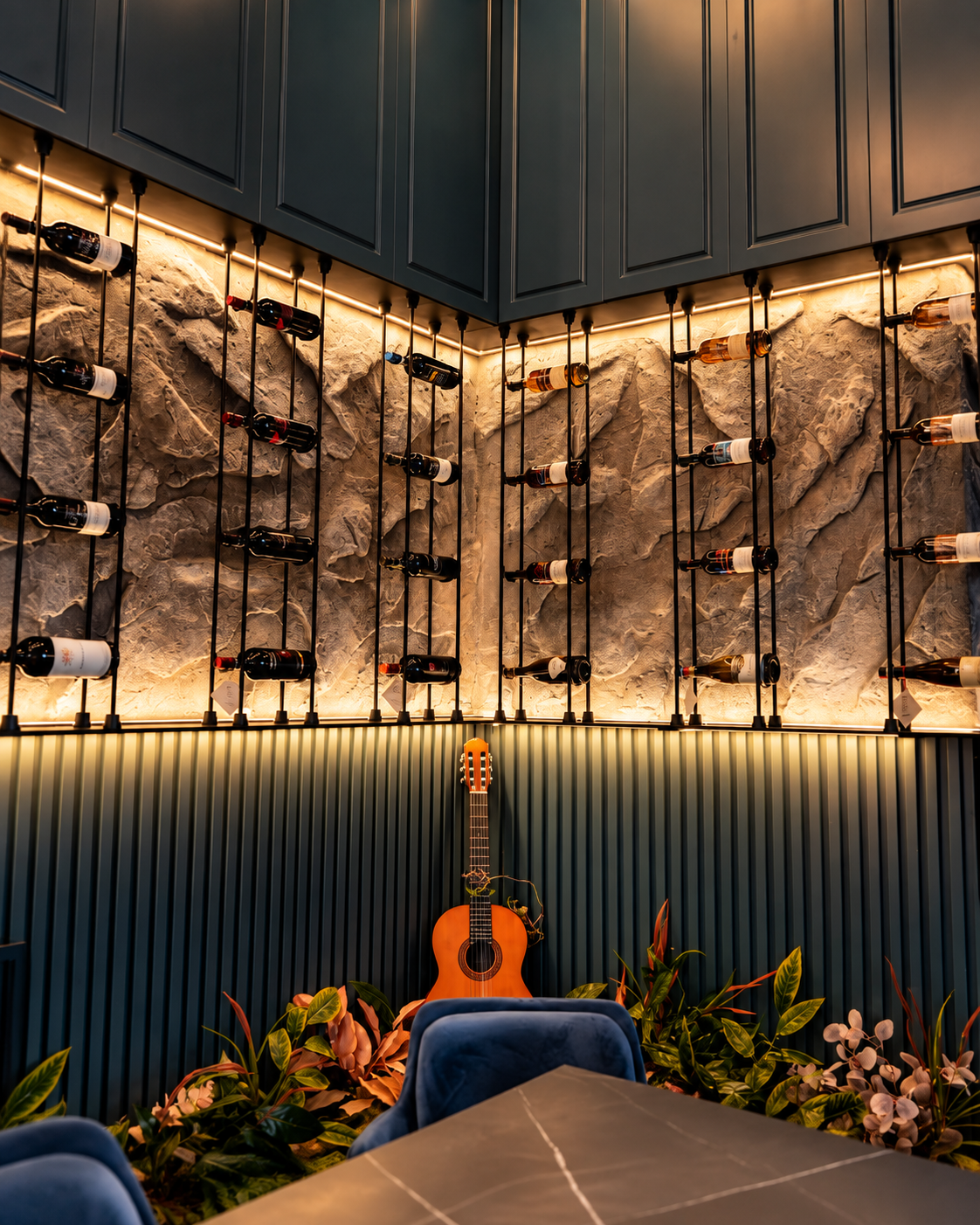 Interior of Rosslyn Wine in Tirana with wine display, modern seating and guitar