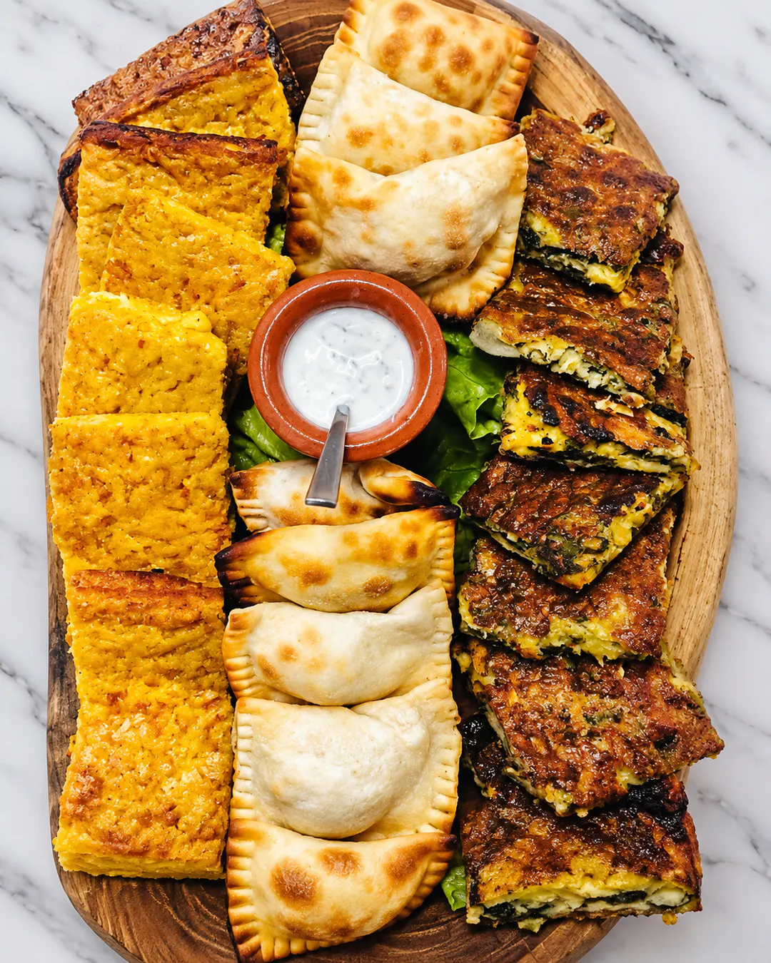 Traditional laknur with seasonal fillings at Oazi Fishtë in Lezhë, Albania