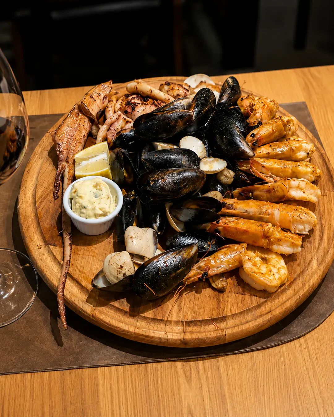 Pjatancë me fruta deti të përziera, karkaleca në skarë, midhje, molusqe dhe kallamarë, të servirura me limon dhe salcë shoqëruese në Trattoria Venezia.
