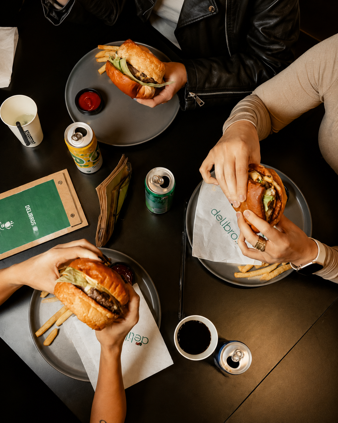 Friends enjoying burgers together at Delibros Tirana