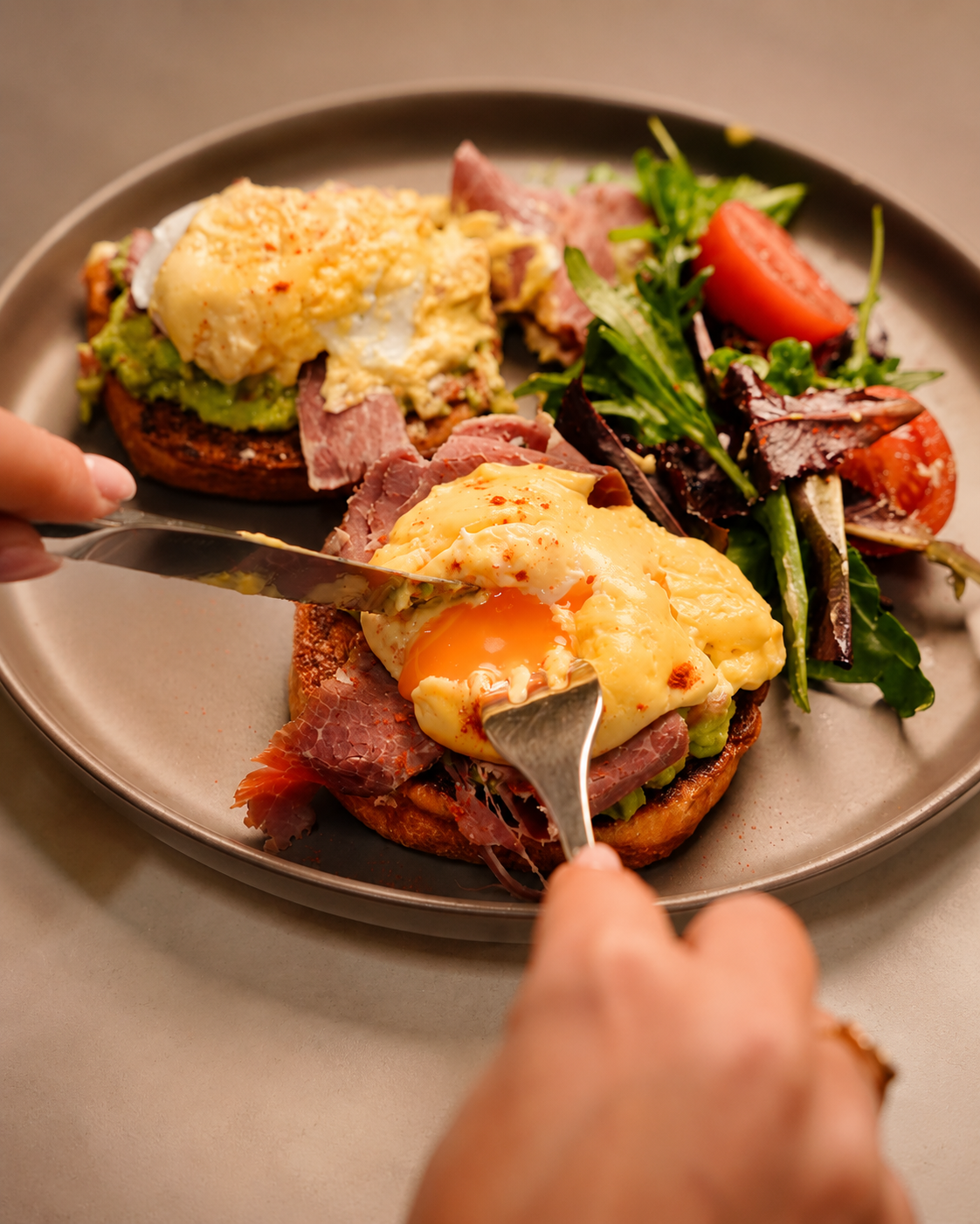 Eggs Benedict with pastrami and salad at Delibros Tirana