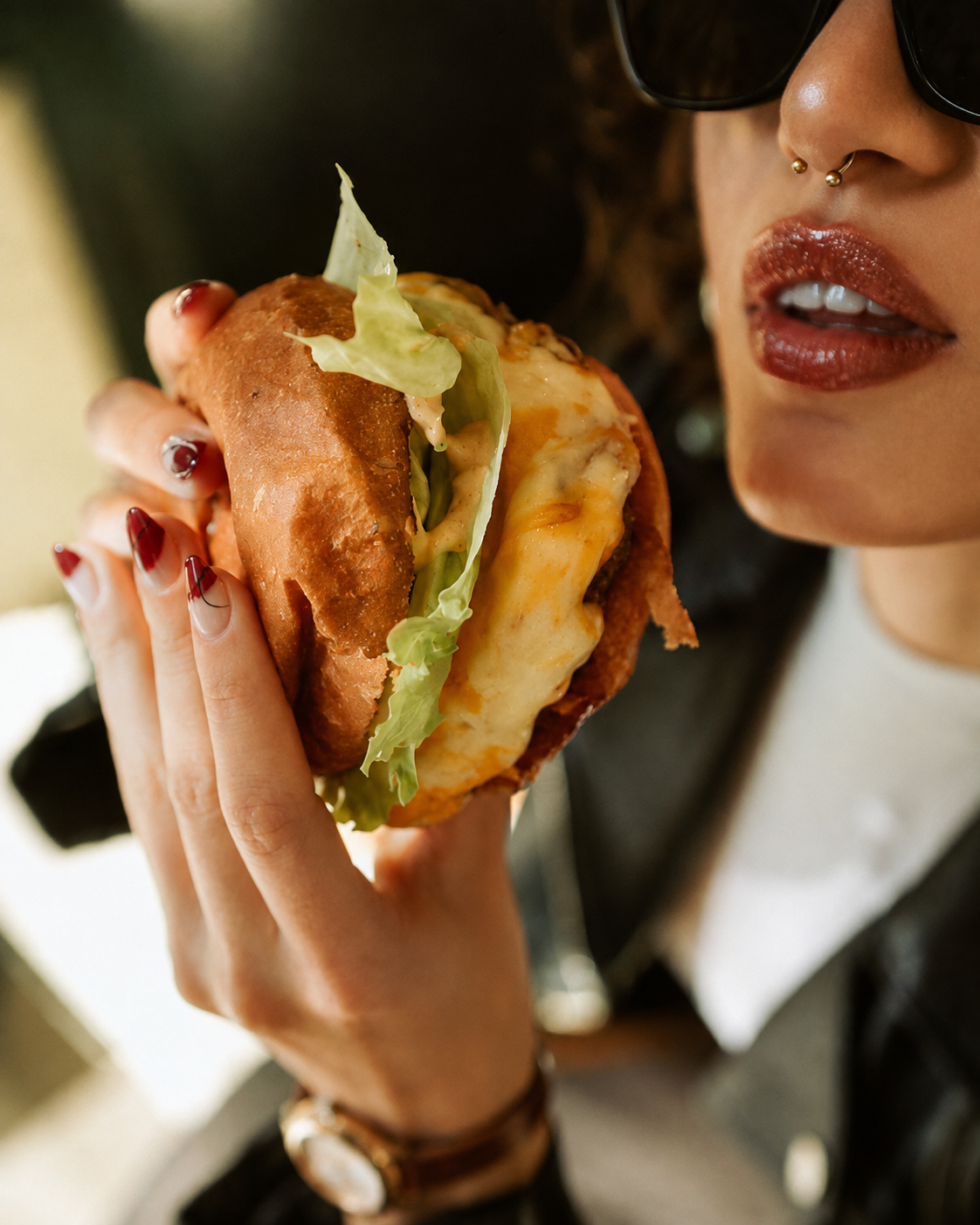 Customer enjoying a freshly prepared burger at Delibros
