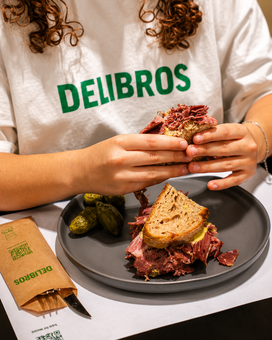 Delibros house-made pastrami served with bread and pickles