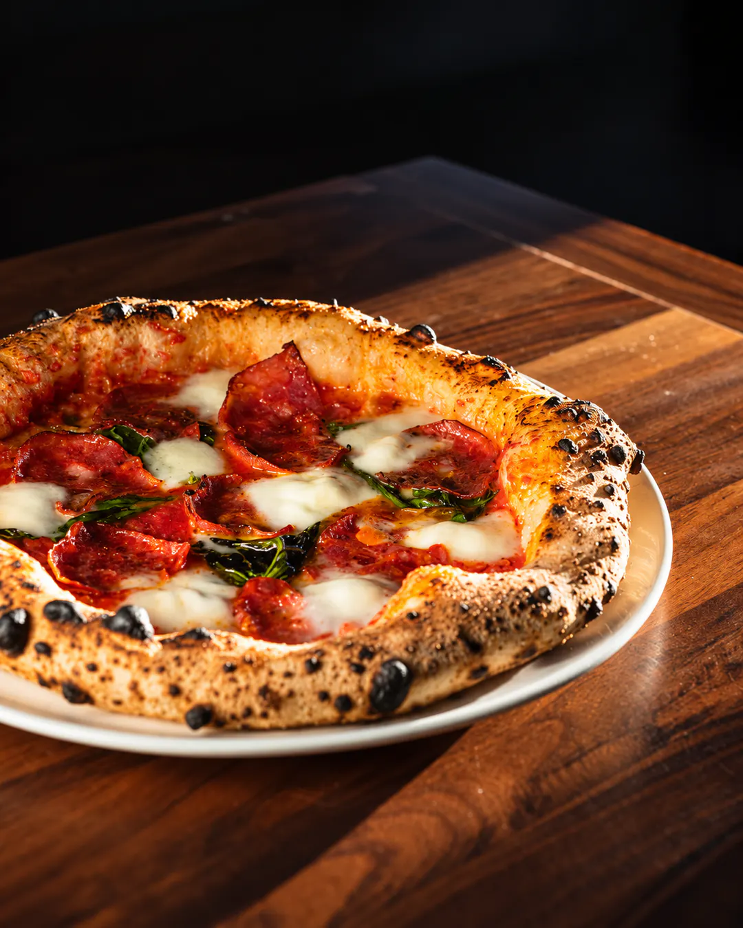 Neapolitan pizza with salami and mozzarella at Global Bite in Tirana