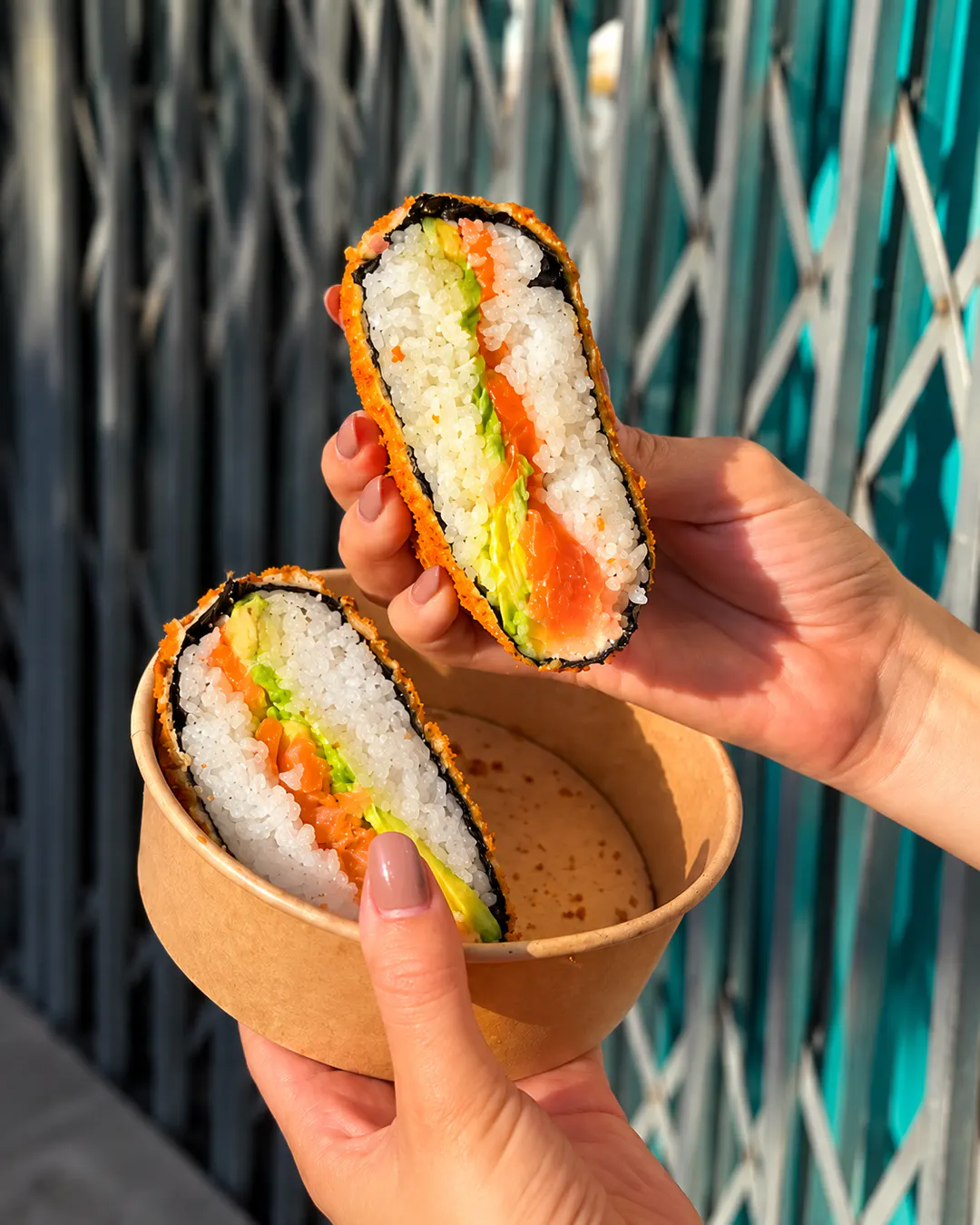 Salmon sushi burger with rice and avocado at Origami Sushi in Tirana