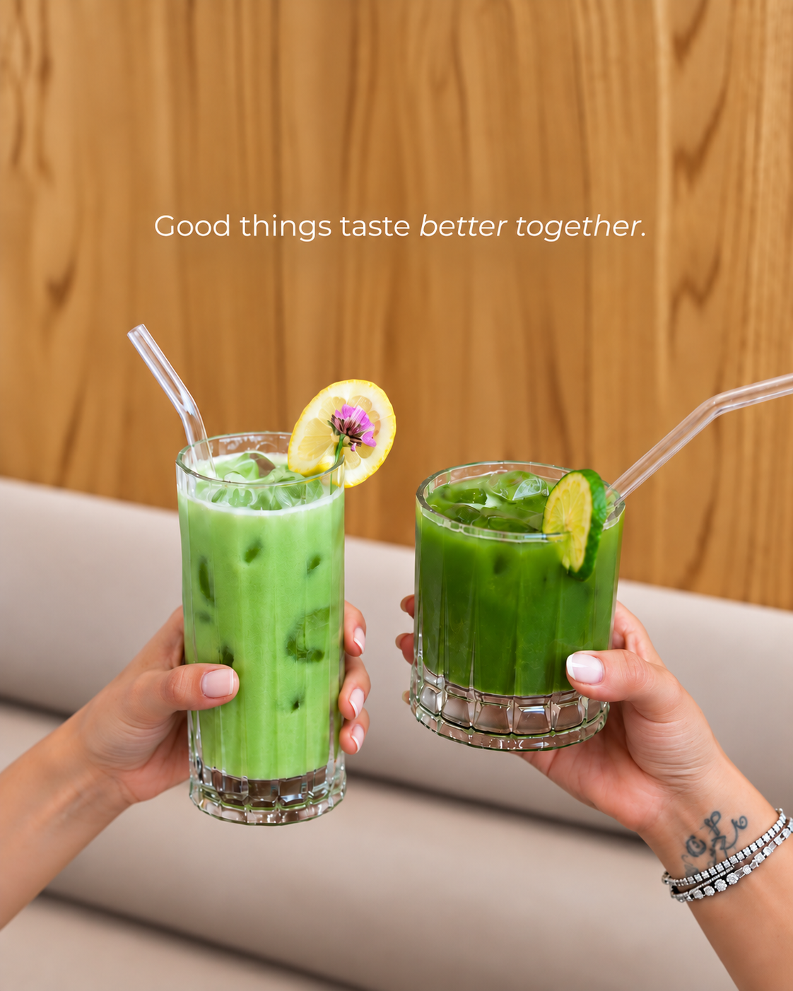 Two refreshing iced green matcha drinks with citrus garnishes at The Blossom Matcha in Tirana, featuring the café's signature beverages.