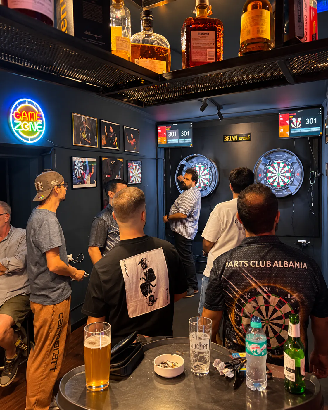 Players enjoying a darts game at Darts Club Tirona in Tirana