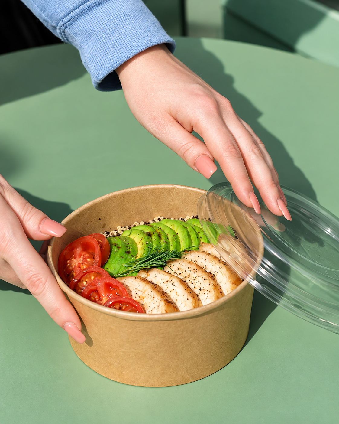 Healthy brunch bowl with grilled chicken, fresh avocado, cherry tomatoes and quinoa at Blossom Matcha in Tirana.