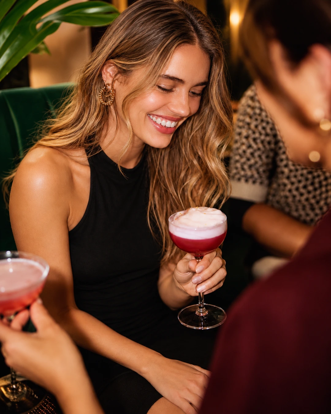Guest enjoying a foamy cocktail at ZABÒ Garden in Tirana.